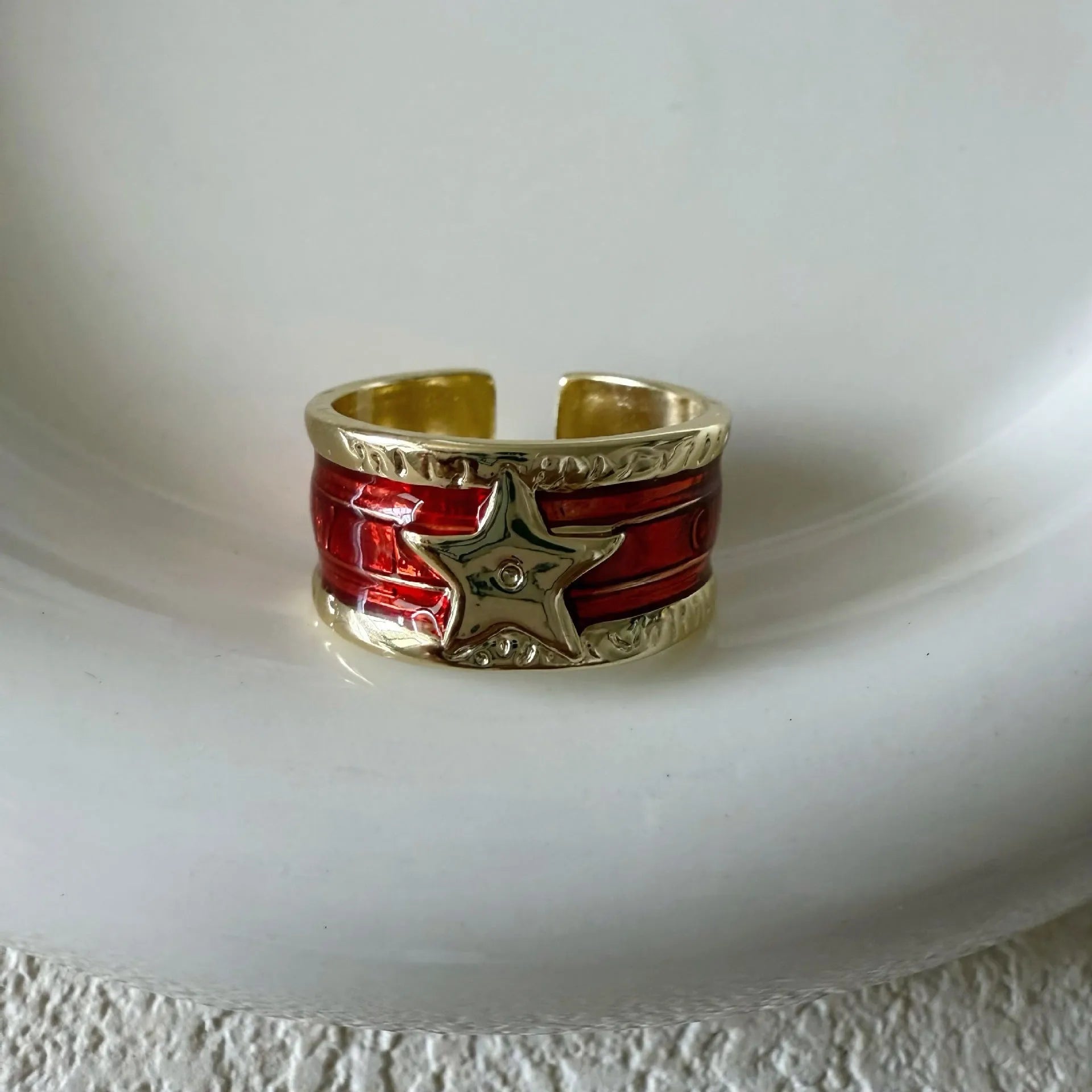 Women's adjustable copper ring with distressed XINGX drop oil design in geometric shape showing colour options