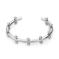 Stainless steel C-shaped bracelet with textured rivet and bean bead design in gold colour.