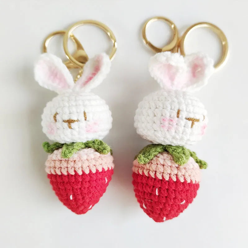 Hand-woven white wire pendant charm with a cartoon rabbit and strawberry design on a key.
