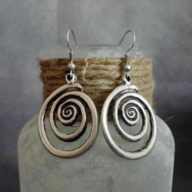 Geometric spiral earrings with distressed silver finish, measuring 5cm long