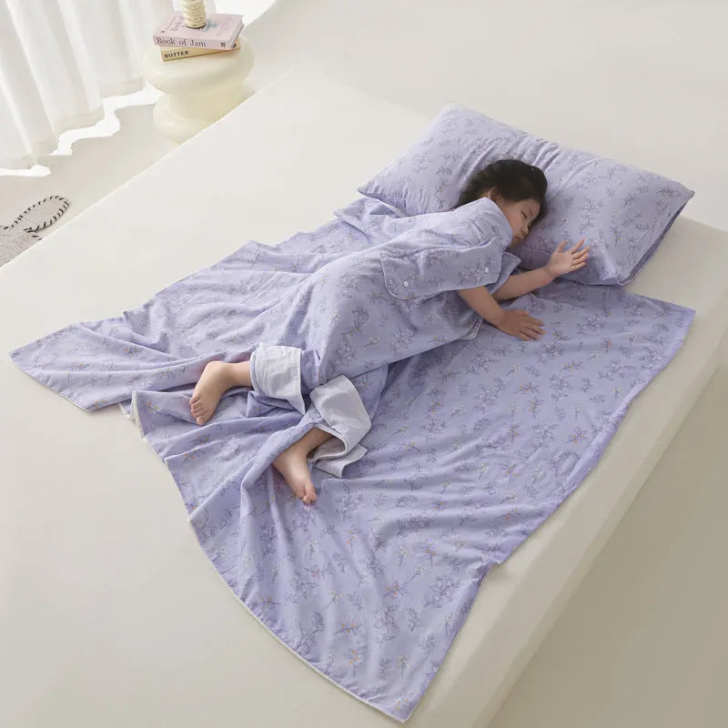 Patterned anti-kick sleeping bag blanket laid flat on a bed, showing its quilted texture.