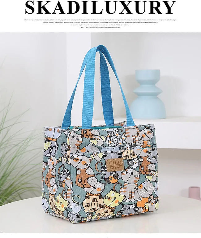 Women's printed canvas tote bag with aluminium hardware in a choice of floral and cat designs.