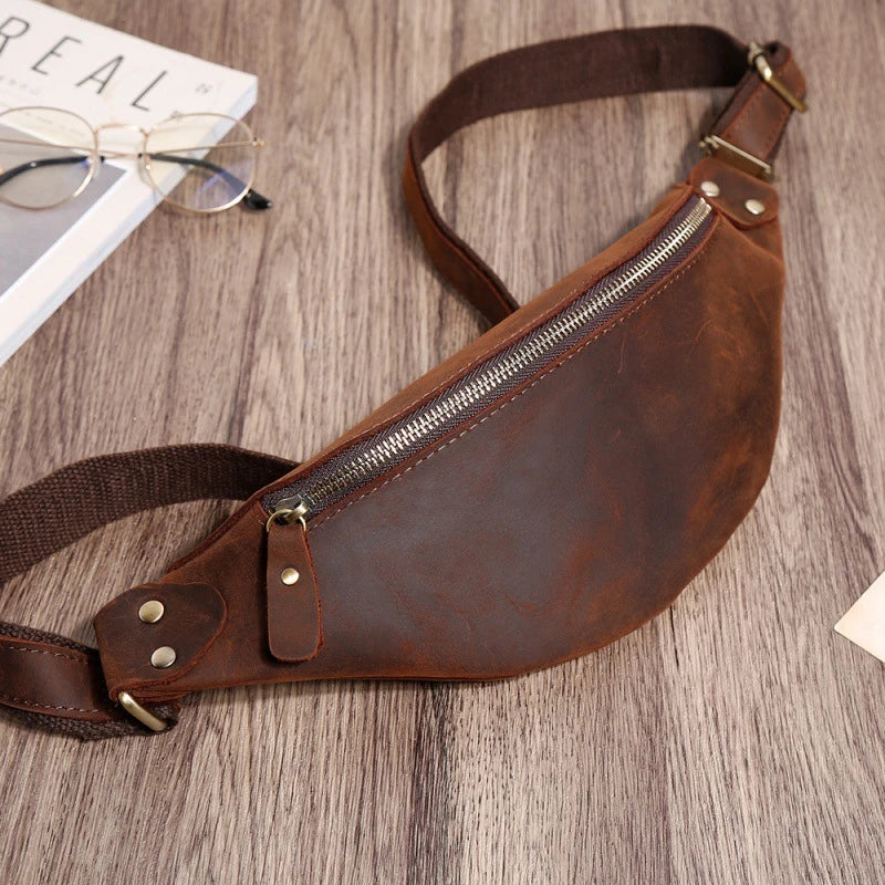 Durable vintage-inspired cowhide crossbody bag with single adjustable shoulder strap, roomy interior, and secure zipper closure