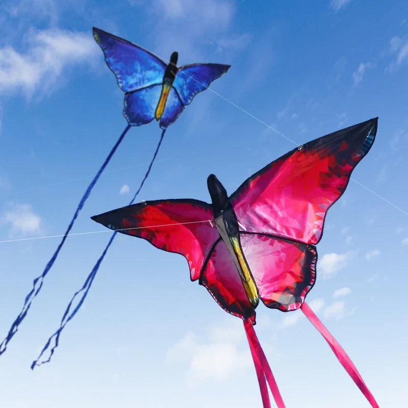 Vibrant red and blue butterfly kite soaring through the skies over New Zealand's scenic landscapes