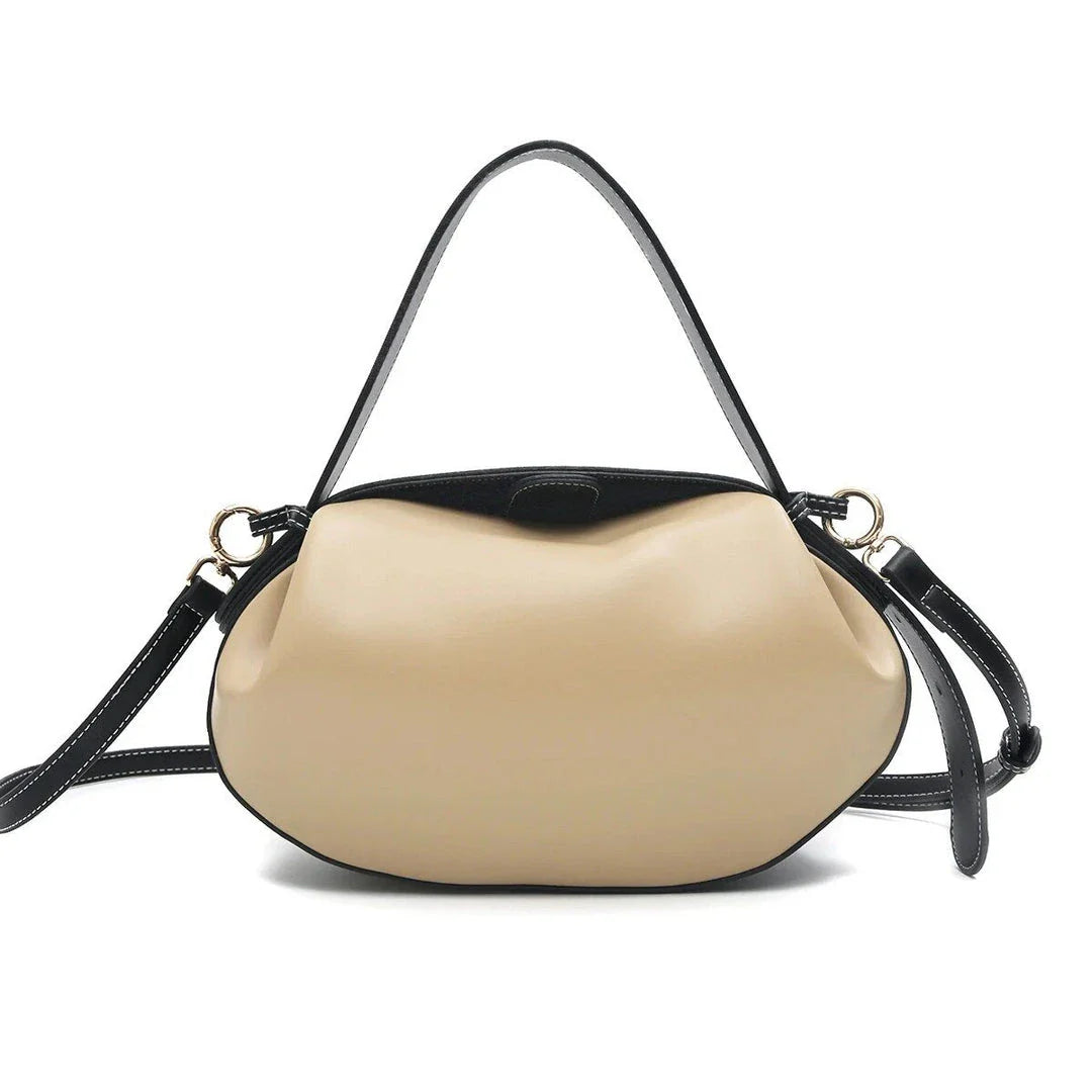 A stylish circular vegan leather handbag with a unique rugby-inspired design, perfect for Kiwi fashion enthusiasts