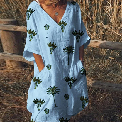 Vibrant leaf print casual dress with V-neck and flared silhouette, perfect for the Kiwi lifestyle