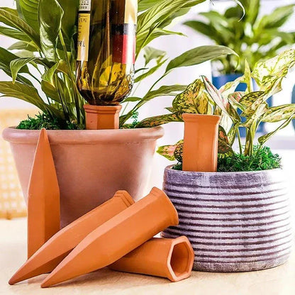 Set of four terracotta plant watering spikes for effortless hydration of potted plants