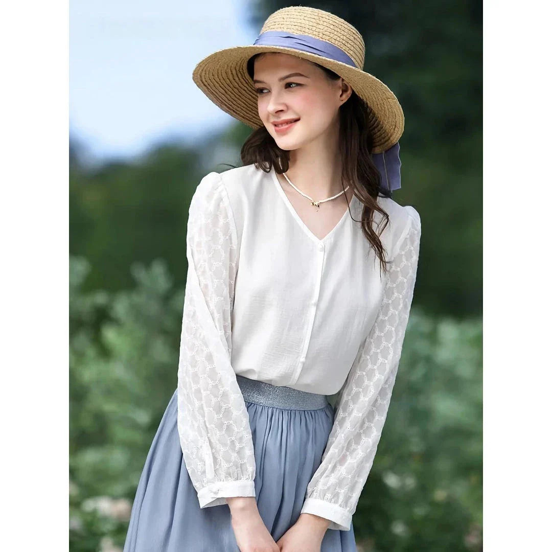 Elegant and versatile French-inspired women's blouse in a classic white color