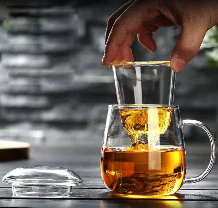 A sleek, minimalist glass tea mug with a touch of Chinese-inspired elegance, perfect for enjoying hot or cold beverages.