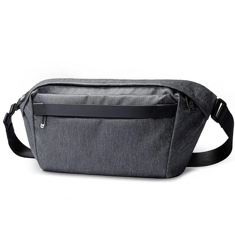 A grey one-shoulder crossbody chest bag with a zippered closure and dedicated pockets for the modern, active Kiwi man