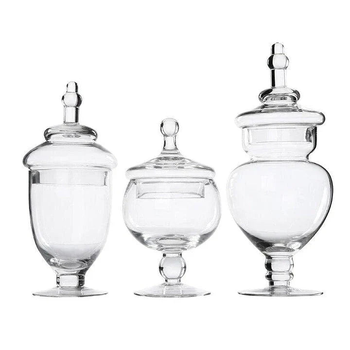 A transparent glass candy jar with a secure lid, perfect for serving sweets and treats at a wedding celebration.