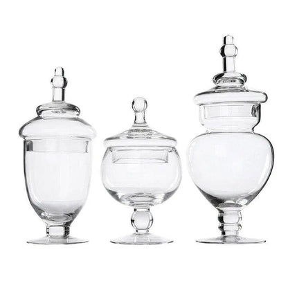 A transparent glass candy jar with a secure lid, perfect for serving sweets and treats at a wedding celebration.