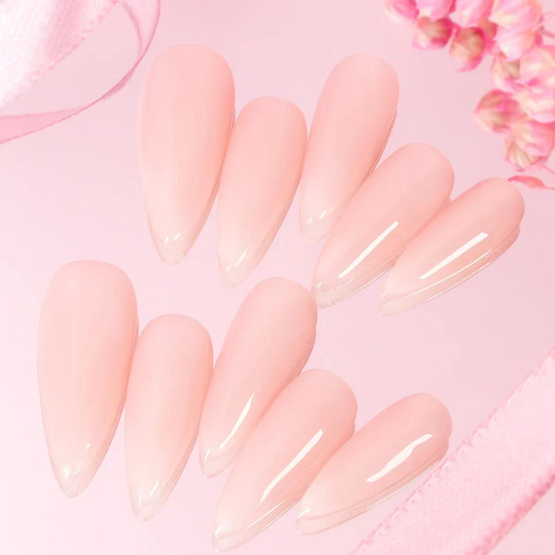 Handcrafted nude pink press-on nails with an almond shape, offering a minimalist and sophisticated style