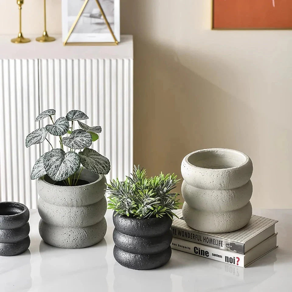 Stylish modern minimalist cement flower pots in two sizes, perfect for showcasing plants and greenery in a Kiwi home