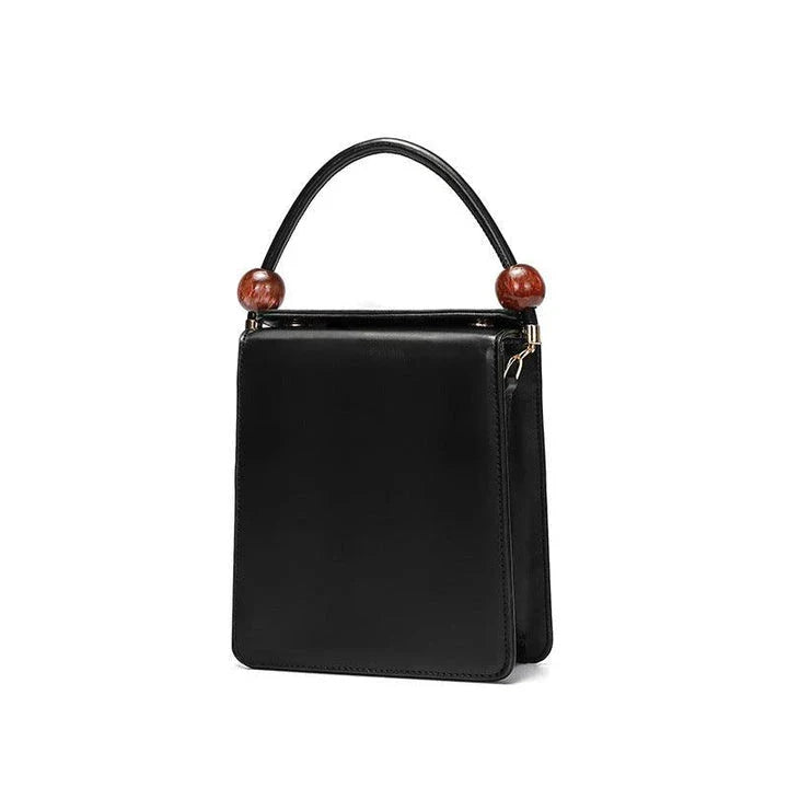 Stylish black crossbody bag with a compact, square shape and colour contrast design, perfect for the modern Kiwi on the go