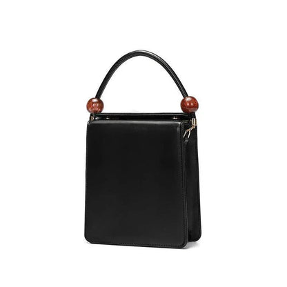 Stylish black crossbody bag with a compact, square shape and colour contrast design, perfect for the modern Kiwi on the go