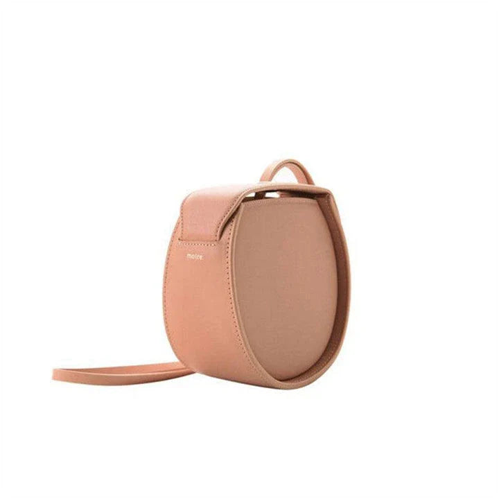 Versatile drawstring shoulder bag in pink with artificial leather construction and diagonal design