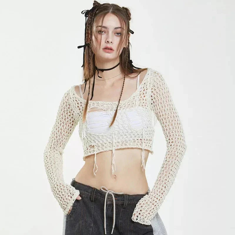 A stylish knitted sweater with hollow-out detailing and tassels, perfect for Kiwi autumn fashion