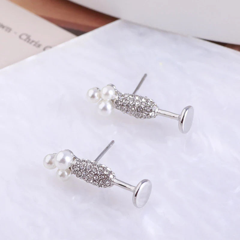 Stunning silver-plated earrings featuring a pearl inlay design, perfect for adding a touch of elegance to any outfit.