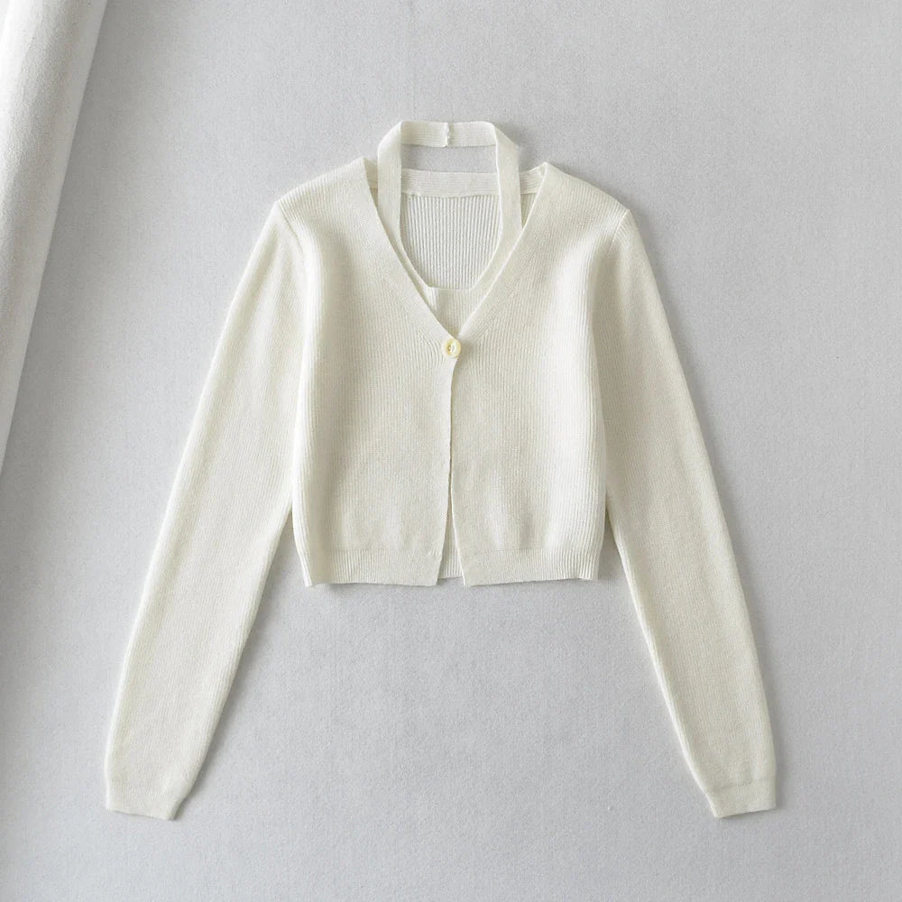 Stylish knitwear vest in a classic black or neutral colour, featuring a V-neck collar and long sleeves for a polished, versatile look.