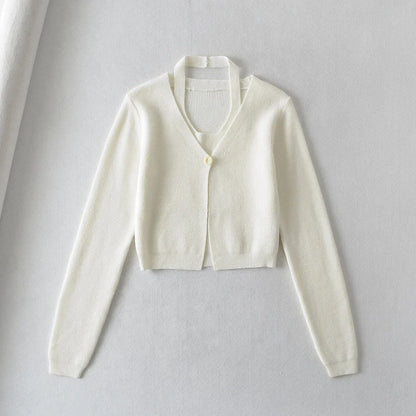 Stylish knitwear vest in a classic black or neutral colour, featuring a V-neck collar and long sleeves for a polished, versatile look.