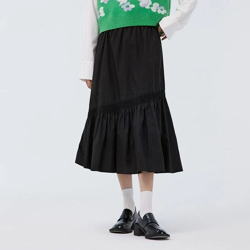 Elegant mid-calf black skirt for women featuring a flattering A-line silhouette and unique irregular hem design