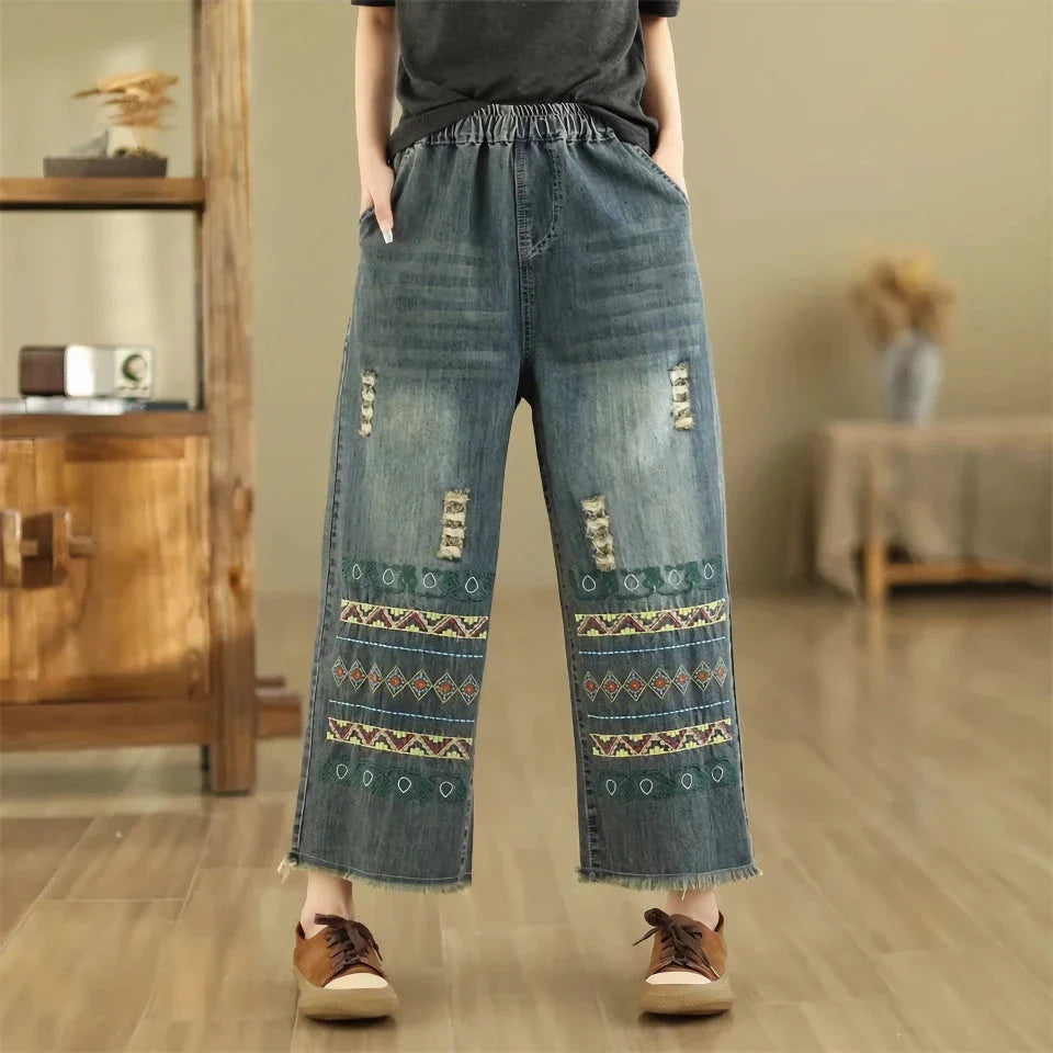 Vintage-inspired embroidered wide-leg jeans in a relaxed, bohemian style with a high-waist design and elastic closure for a personalized fit