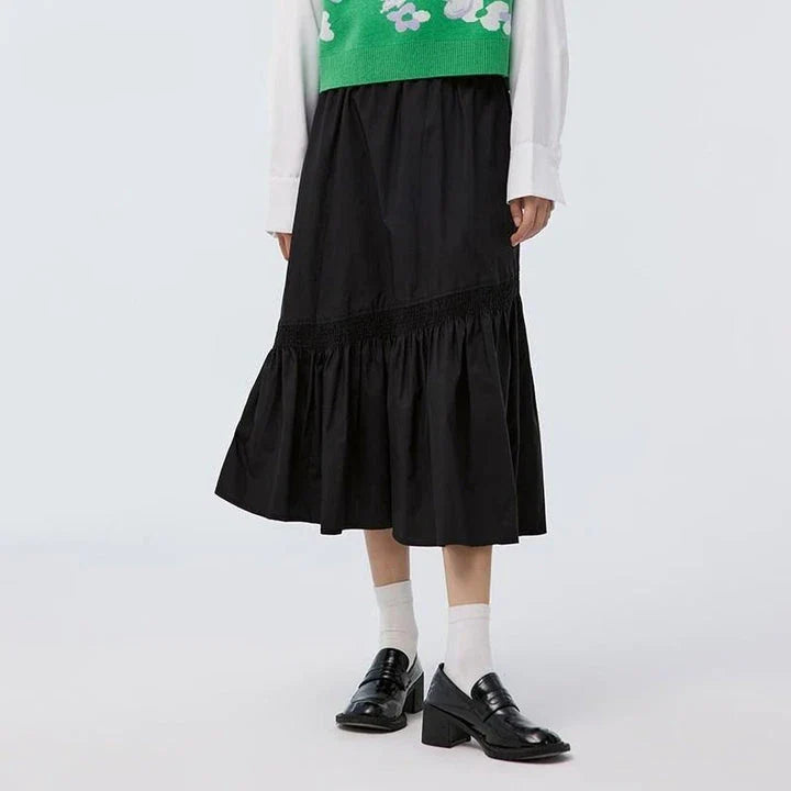 Elegant mid-calf black skirt for women featuring a flattering A-line silhouette and unique irregular hem design