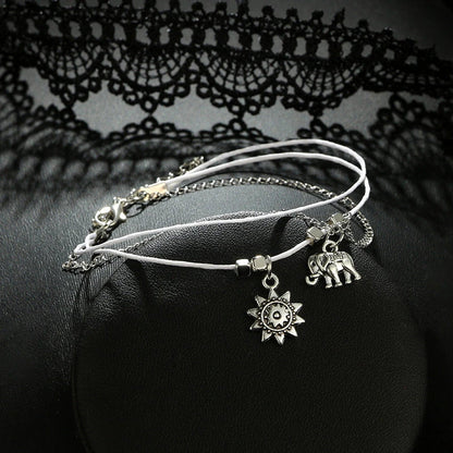 Bohemian-style anklet with star and elephant pendant charms, made from durable zinc alloy in shimmering silver and gold tones