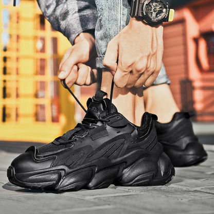 Pair of white, black, and gray casual sports sneakers with leather upper and rubber sole