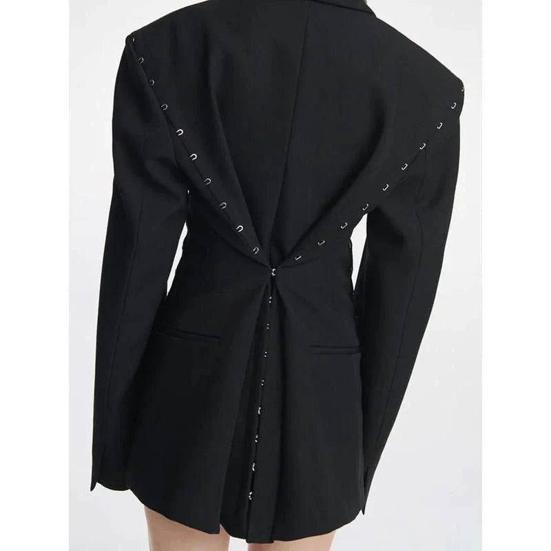 A stylish autumn blazer with a notched metal buckle decoration and camouflage pattern, designed for the modern Kiwi woman