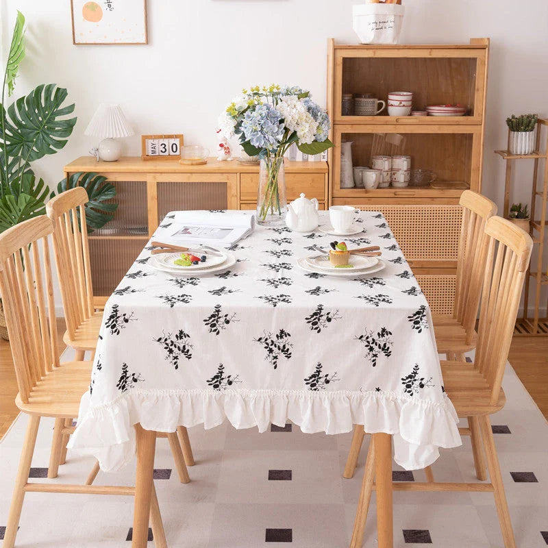 Elegant embroidered floral cotton tablecloth with ruffled edges, perfect for Kiwi homes and hospitality