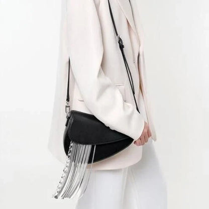 Stylish leather crossbody saddle bag with trendy tassel detail, perfect for everyday use or formal occasions