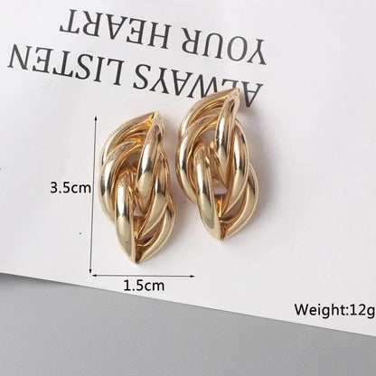 Geometric statement earrings in a luxurious gold finish, featuring a unique hollow twist design for a bold, fashionable look