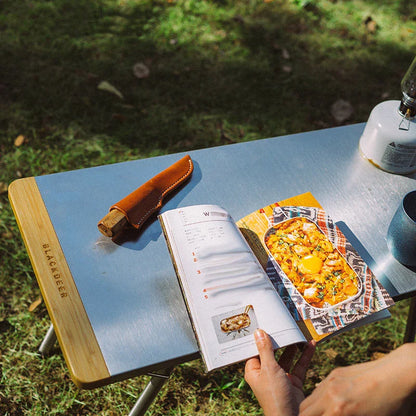 Portable bamboo folding table with stainless steel frame, ideal for outdoor activities like camping, picnics, and BBQs in New Zealand