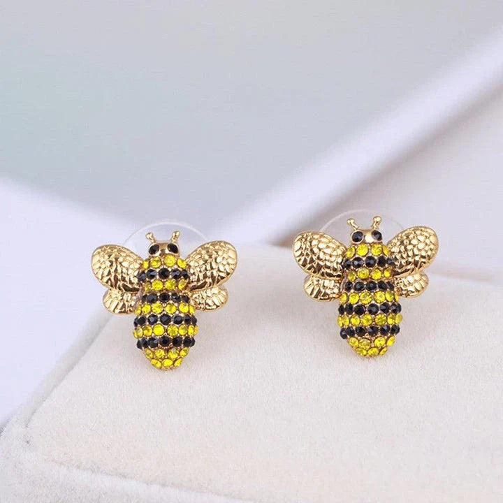 Elegant three-dimensional diamond bee stud earrings in a gold tone, featuring a sparkling design that adds a touch of whimsy and sophistication.