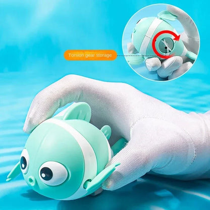 Cartoon fish wind-up bath toy in green, designed for New Zealand toddlers to enjoy during bathtime