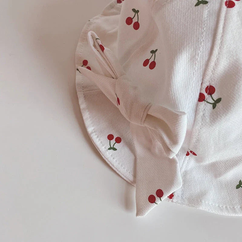 A charming bucket hat for kids featuring a delightful fruit print and cute bow detail, providing excellent sun protection and comfort.