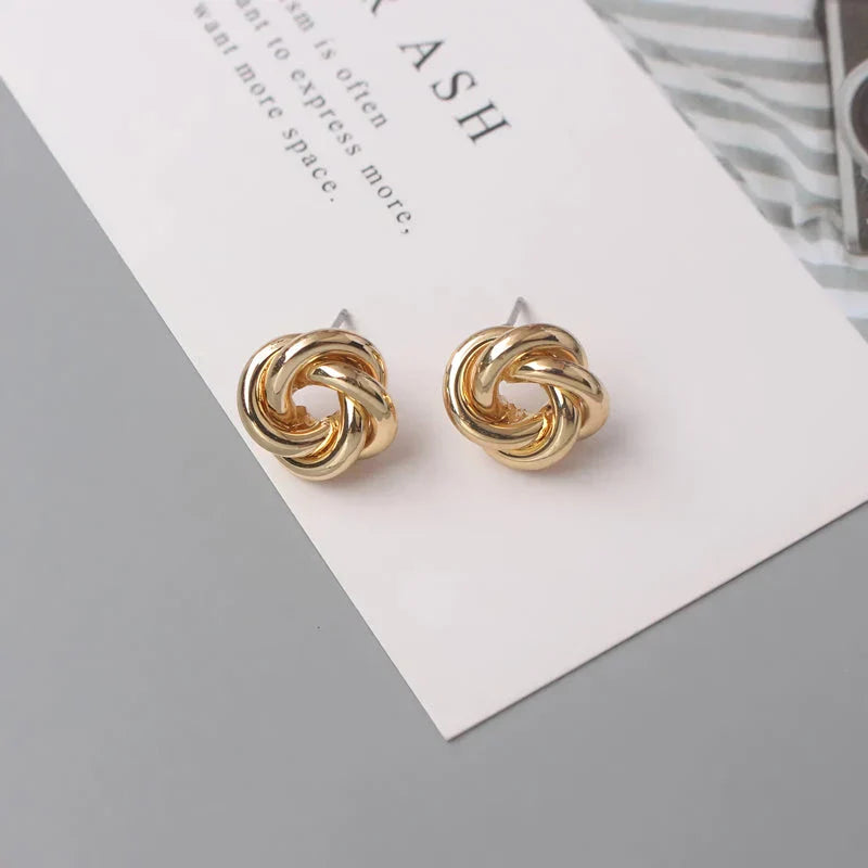 Geometric statement earrings in a luxurious gold finish, featuring a unique hollow twist design for a bold, fashionable look