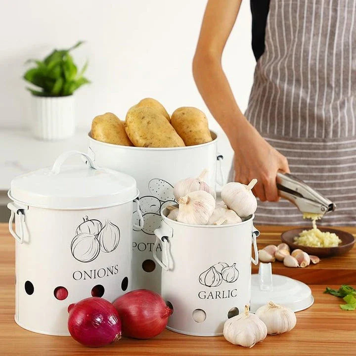 Breathable metal storage bins with handles for storing fresh produce like onions, potatoes and garlic in the kitchen.