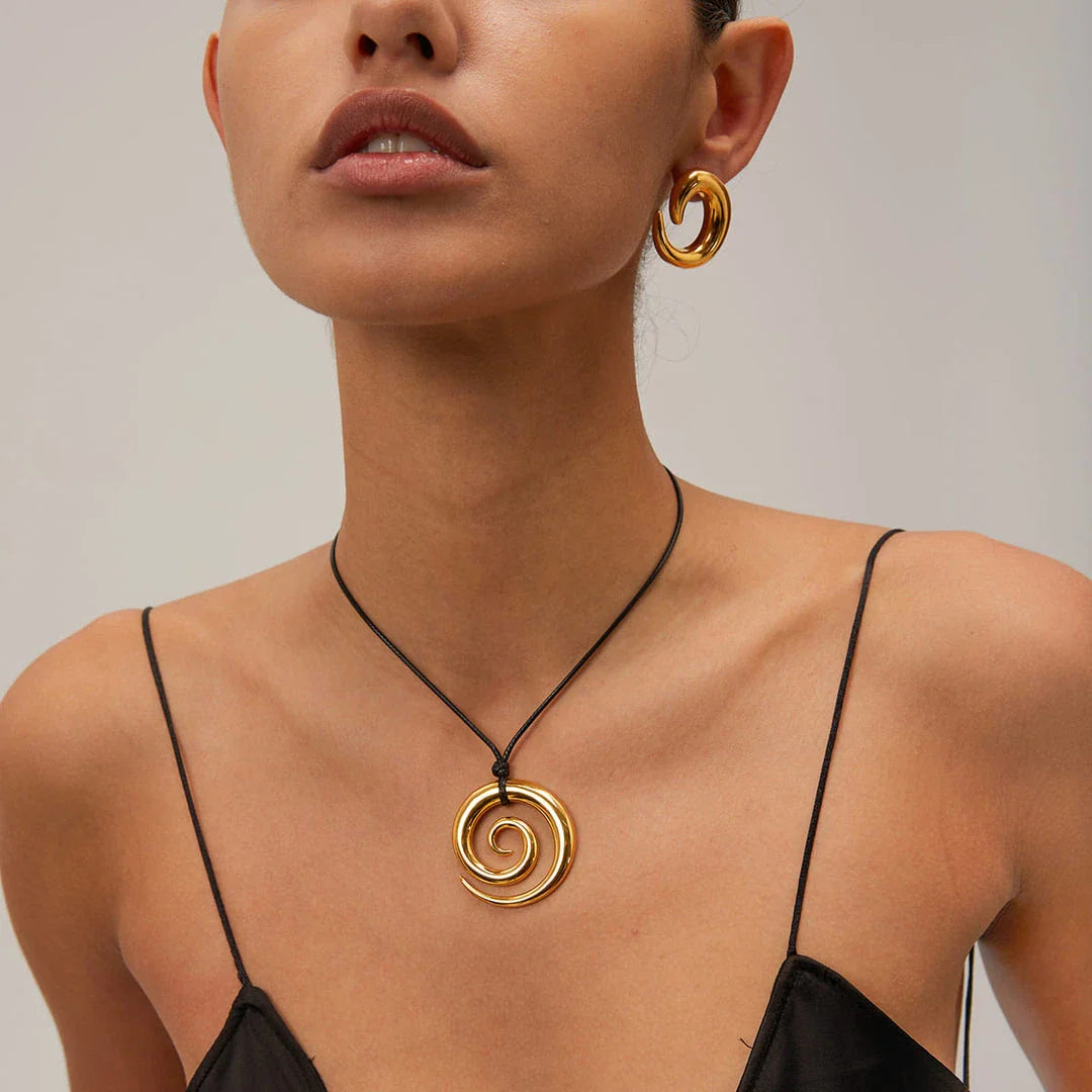 Elegant spiral circle pendant necklace in gold with black rope, a timeless accessory for Kiwi fashionistas