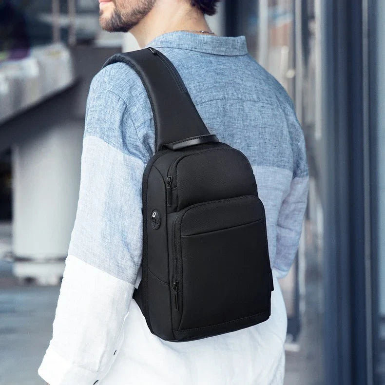 A black, water-resistant crossbody chest bag made from durable Oxford fabric, perfect for everyday use in New Zealand.