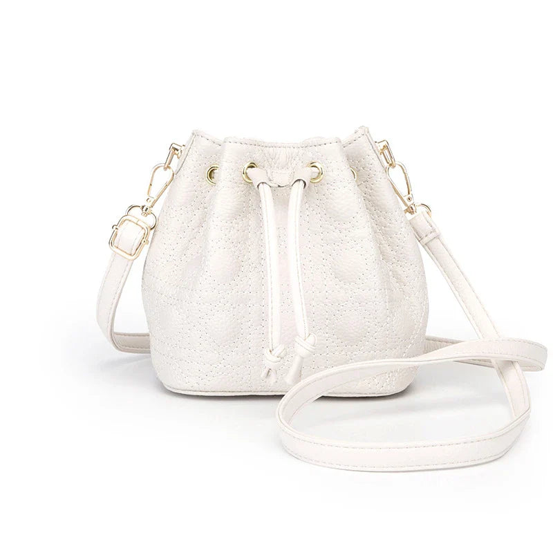 A stylish cowhide bucket handbag in cloud pearl color, featuring a modern design and versatile functionality.