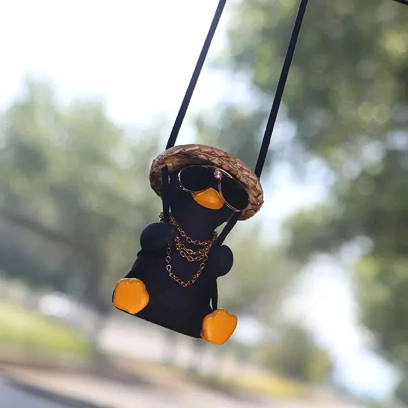 A charming swinging duck car pendant with a guitar and coke-themed design, adding a touch of Kiwi personality to your vehicle.