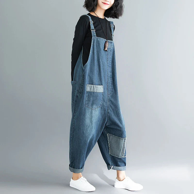 Women's plus-size denim overalls featuring a sustainable, high-waist design with distressed detailing