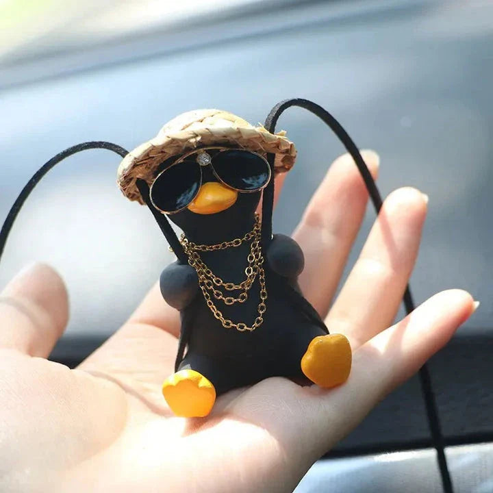 A charming swinging duck car pendant with a guitar and coke-themed design, adding a touch of Kiwi personality to your vehicle.