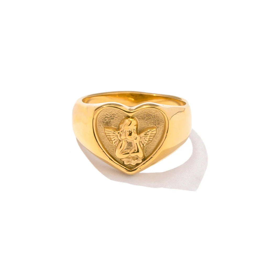 Closeup of a gold plated stainless steel ring with a heart and angel design, a classic and elegant accessory