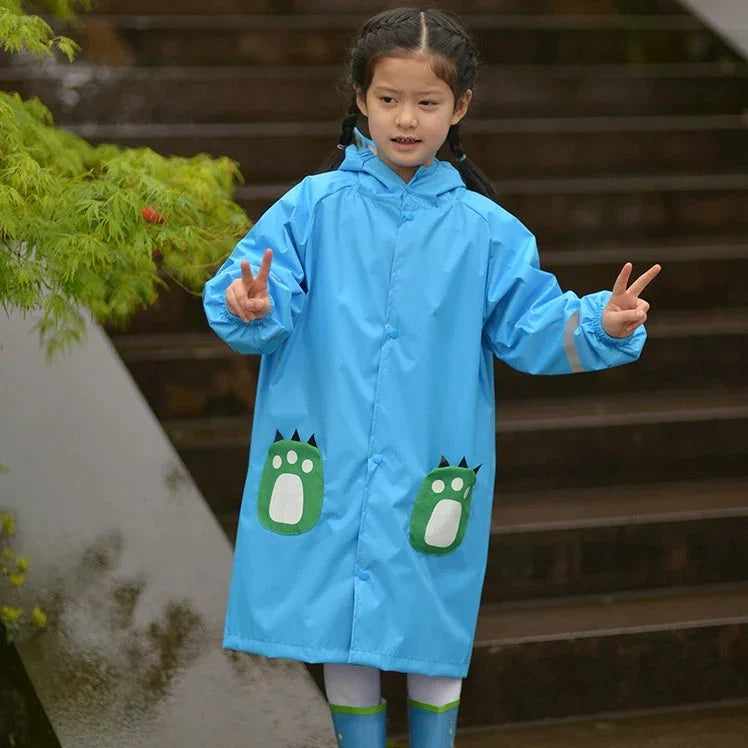 A child wearing a vibrant yellow waterproof raincoat jumpsuit, perfect for playing outdoors in the rain.