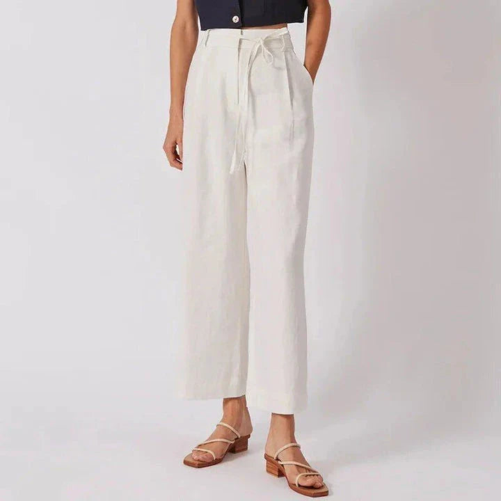 Elegant high-waist linen trousers with Korean-inspired design, featuring lace-up detail and button decorations for a sophisticated and comfortable look.