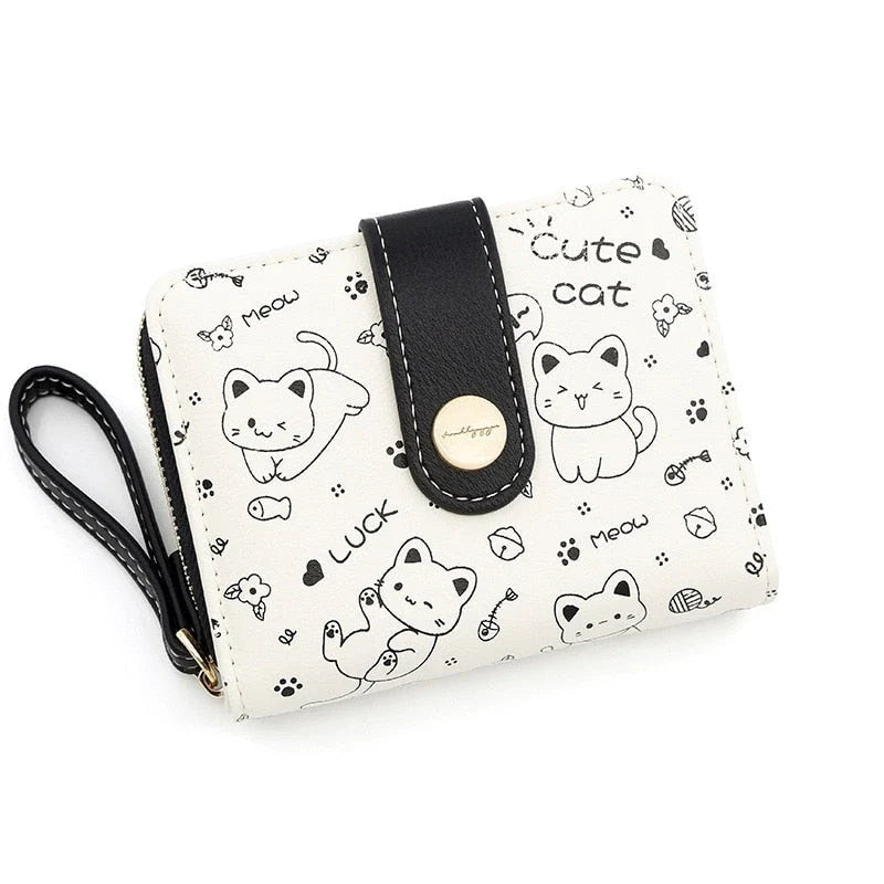 A stylish compact wallet featuring a playful cat-themed design with a tilted head motif, available in a range of candy-inspired colours.